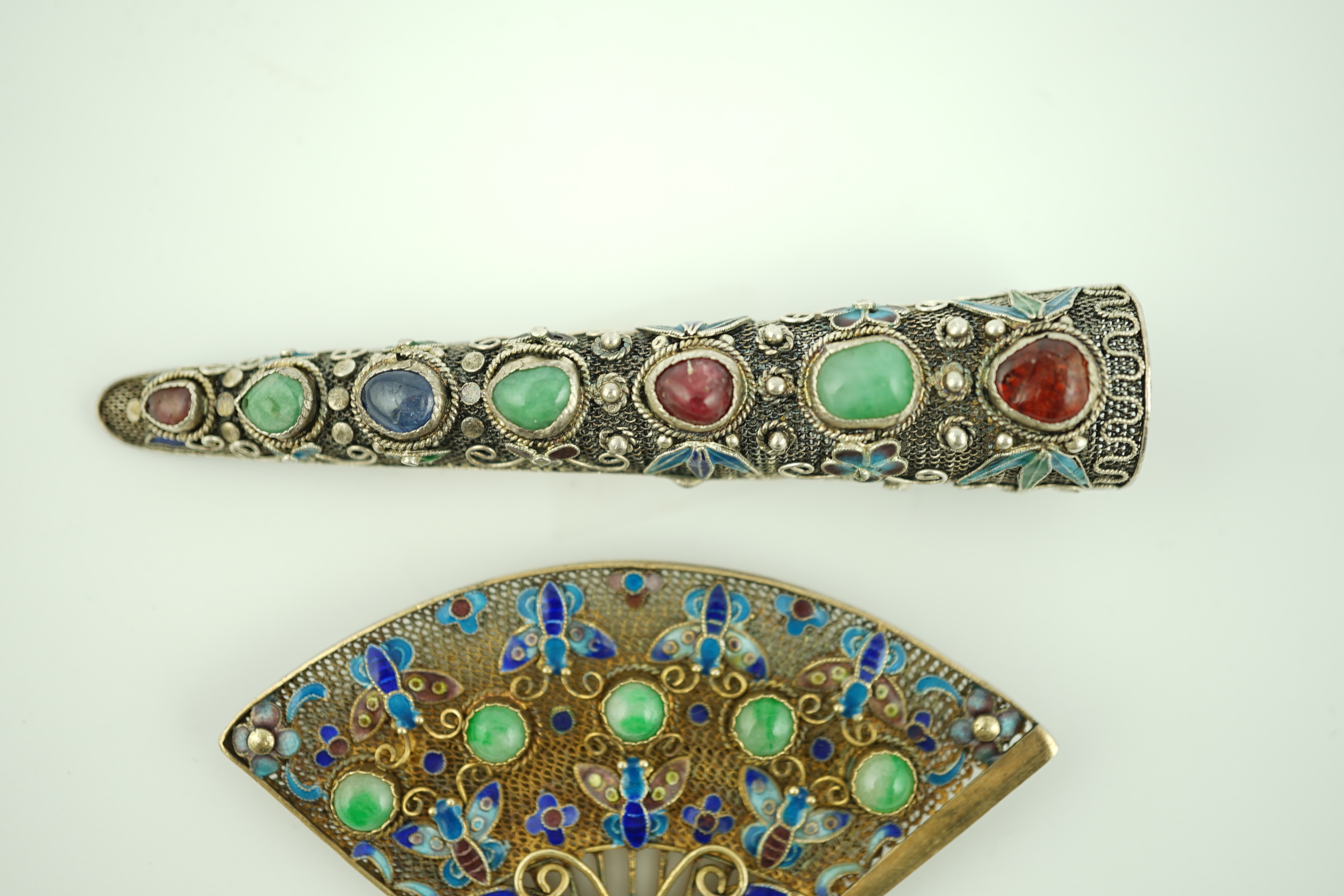 A Chinese silver, enamel and jadeite 'fan' brooch, width 69mm and a similar nail guard brooch, 87mm